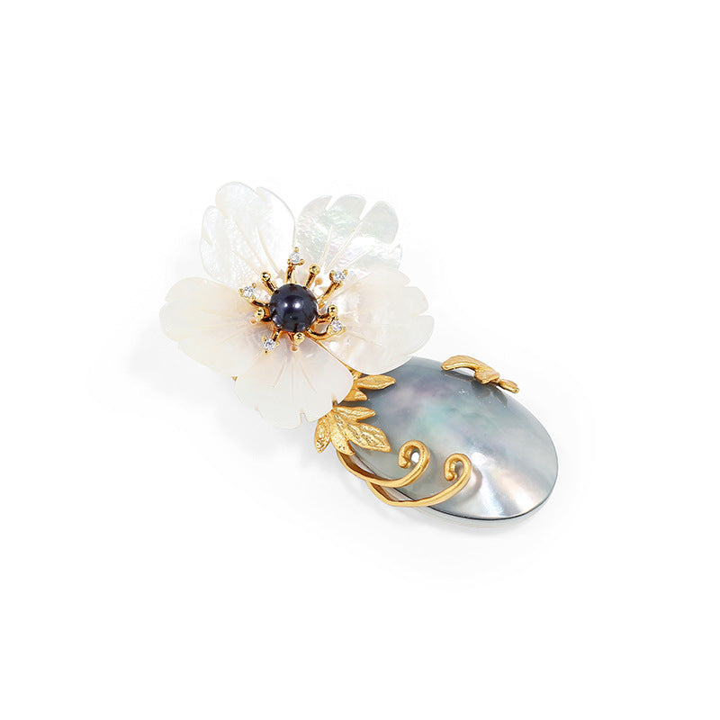 Natural mother-of-pearl brooch with golden stamens and diamonds