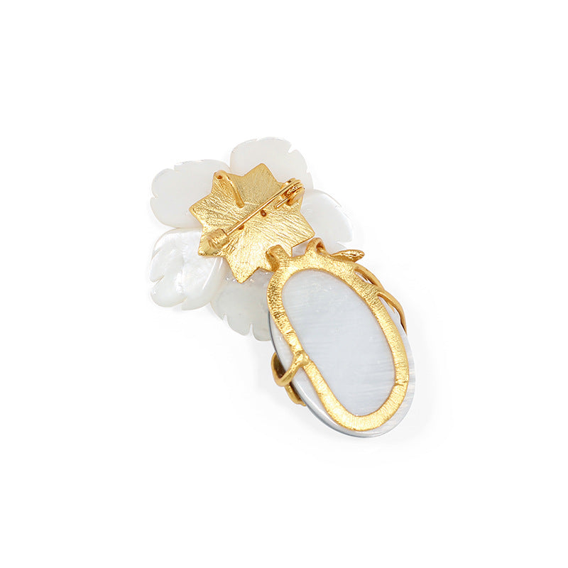 Natural mother-of-pearl brooch with golden stamens and diamonds